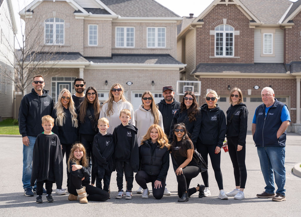 The West Team and volunteers gathered with donated food at the Bridlewood Food Drive