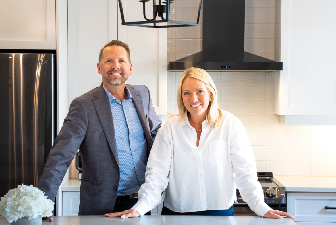 Josh and Richelle West of The West Team standing in a modern kitchen
