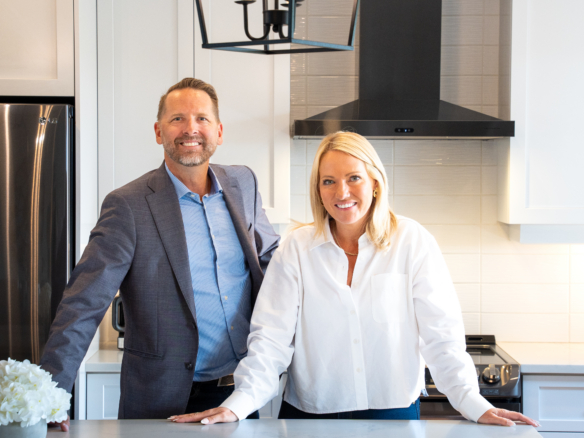 Josh and Richelle West of The West Team standing in a modern kitchen