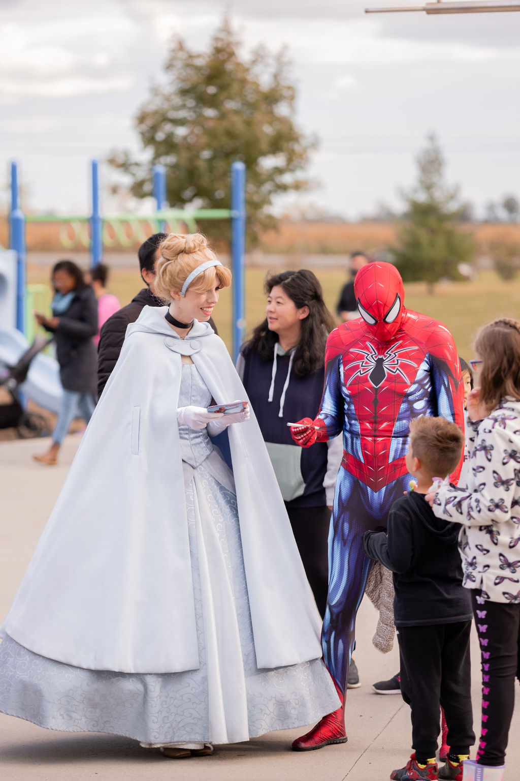 Cinderella and Spider-Man greeting children at The West Team’s annual Pumpkin Pickup