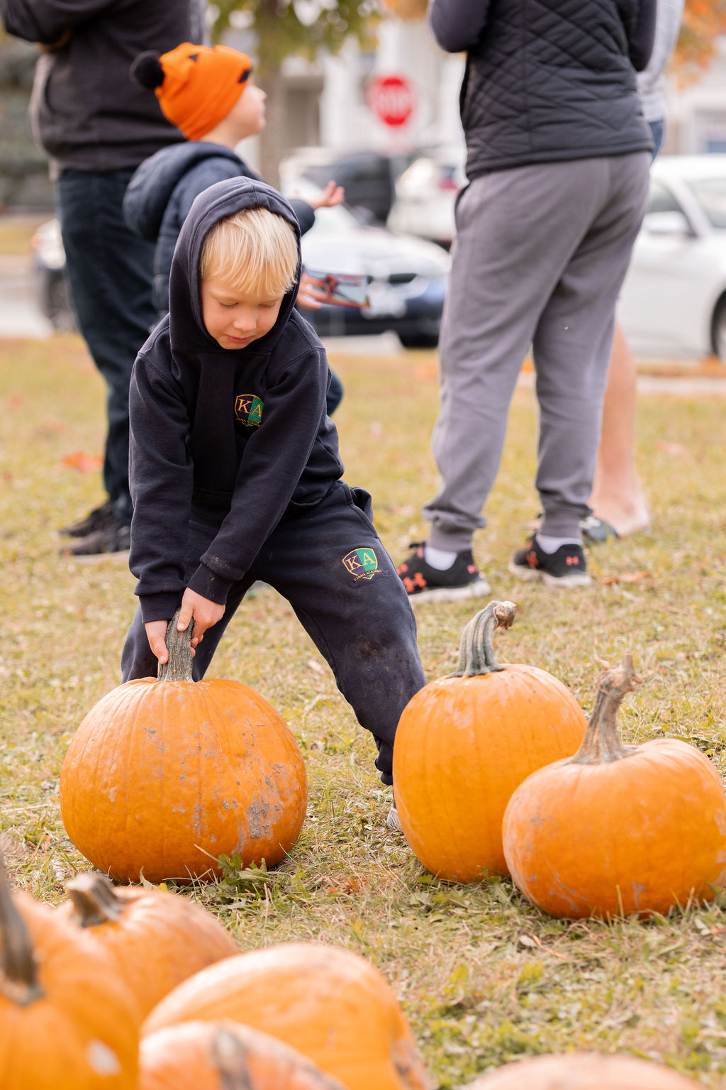 Child choosing a pumpkin at The West Team’s annual Pumpkin Pickup