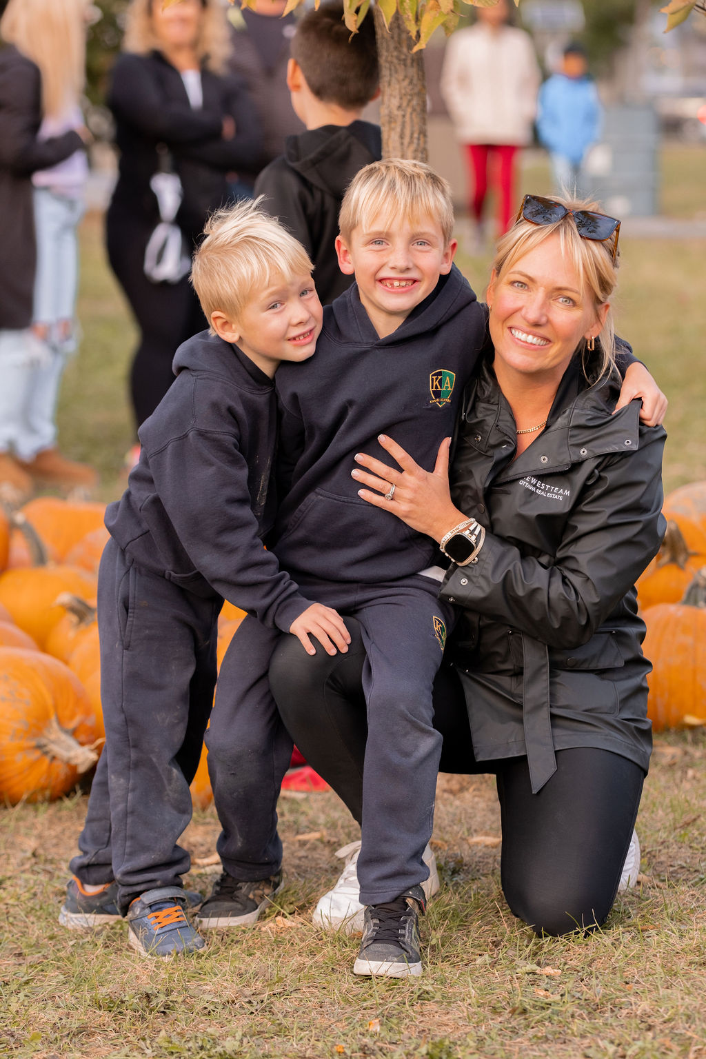 Richelle West posing with two children at The West Team’s annual Pumpkin Pickup