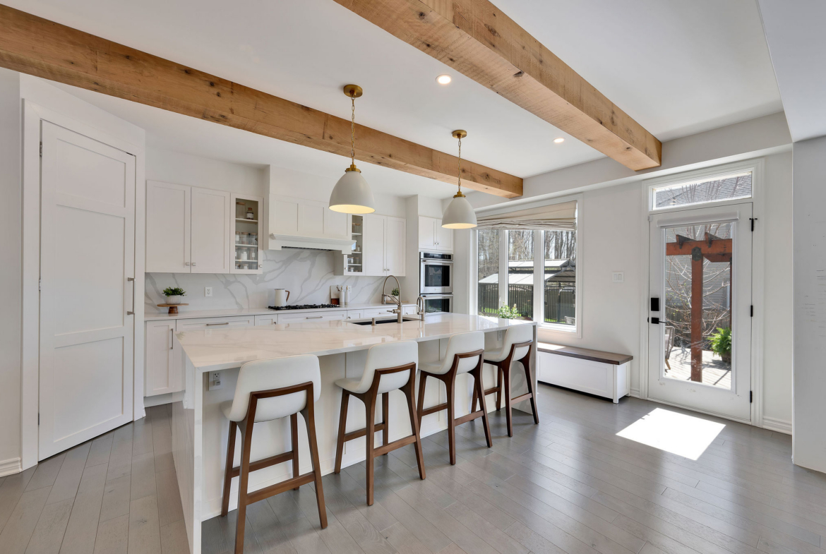 Bright, professionally presented kitchen with a large island and pendant lighting